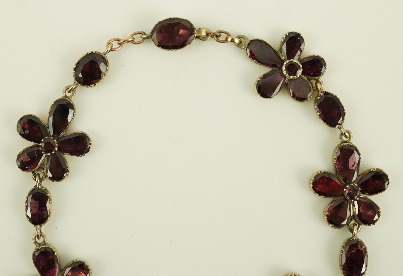 An early Victorian gold and foil backed garnet cluster set bracelet